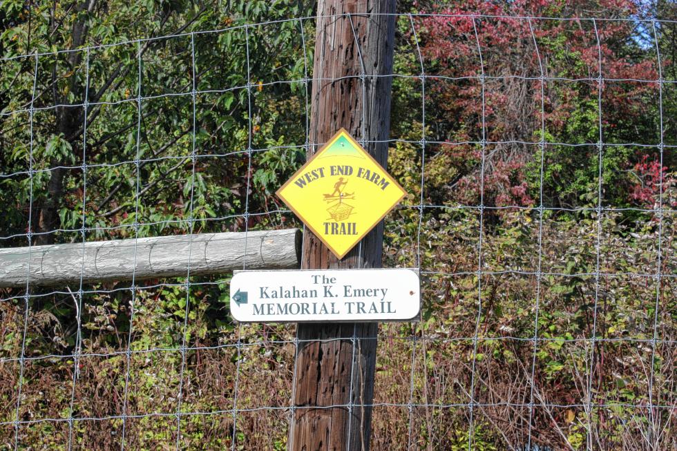 Signs mark the West End Farm Trail and the Kalahan K. Emery Memorial Trail at Carter Hill Orchard. (JON BODELL / Insider staff) - 
