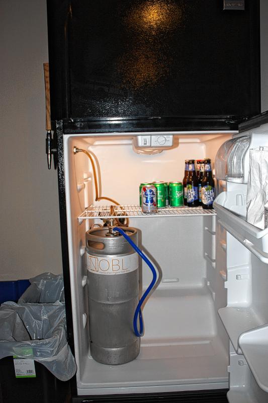 The fridge has a mini keg of Nobl cold-brewed iced coffee with a tap on the outside of the fridge. Pour yourself a glass - just leave 2 bucks in the glass jar on top as a courtesy. And is that beer in there, too? Yes, it is. (JON BODELL / Insider staff) - 
