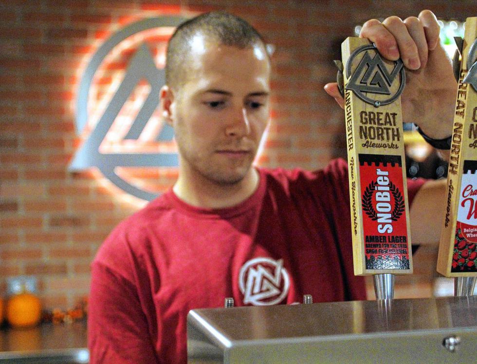 Joseph Getts, tasting room manager at Great North Aleworks, pours some SNOBier, a specialty beer made just for the SNOB festival, from a tap during brew day last weekend. (BRIAN PARDA / For the Insider) -