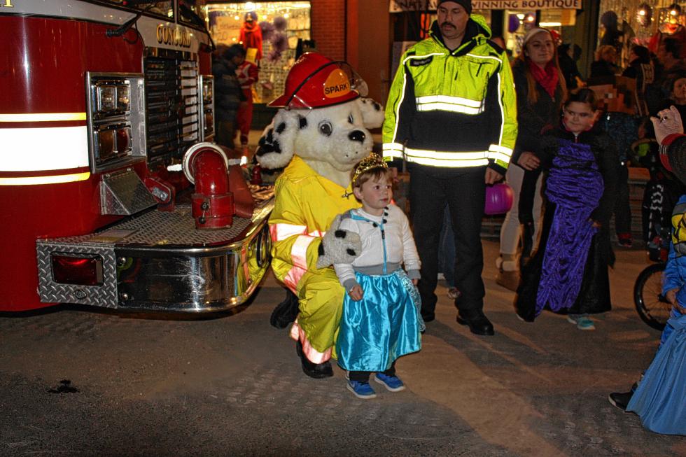 Graham Stearns, 3½, poses for a picture with Sparky the fire dog while decked out in his Elsa costume. Graham’s two favorite things in the world are “Frozen” and fire trucks, said his mom, Sarah. When asked to choose which he likes better, Graham admitted it was the fire trucks. But on this night, he didn’t have to choose! (JON BODELL / Insider staff) - 
