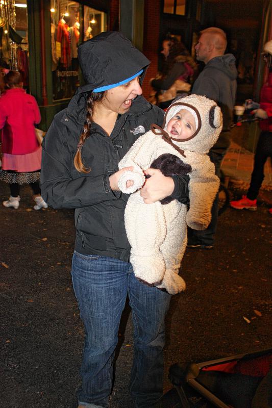 Jon's daughter, Julia, 6 months, takes in the Halloween Howl scene with her mom, Aimee. Although she was dressed as a ferocious bear, most people thought she was more cute than scary. (JON BODELL / Insider staff) - 
