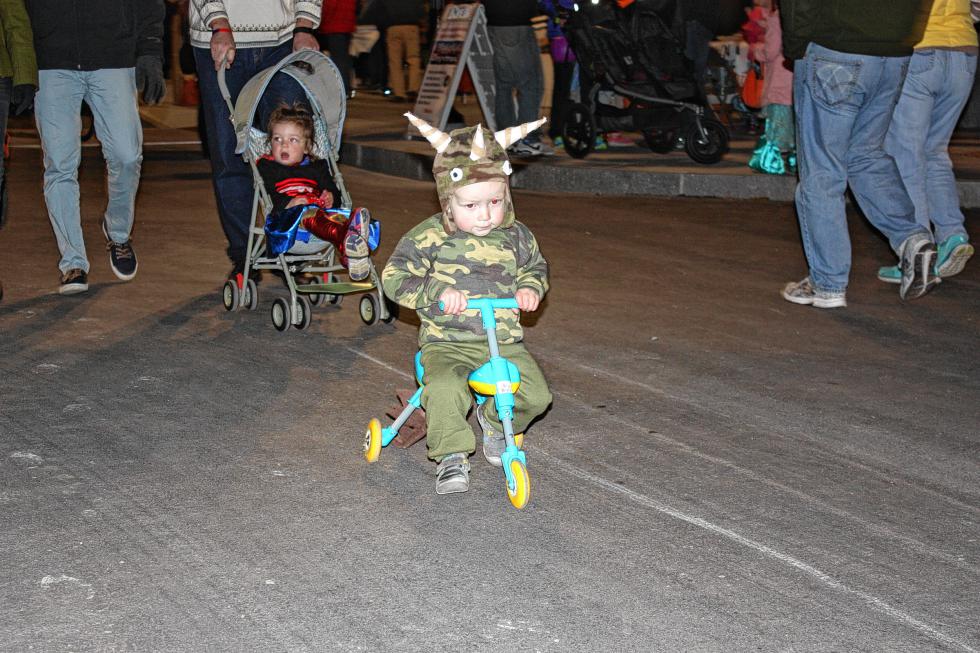 Camden Telfer, 2, of Manchester is clearly too cool to walk around all night, so he crusied Main Street on his bike. Many kids were surely jealous. (JON BODELL / Insider staff) -