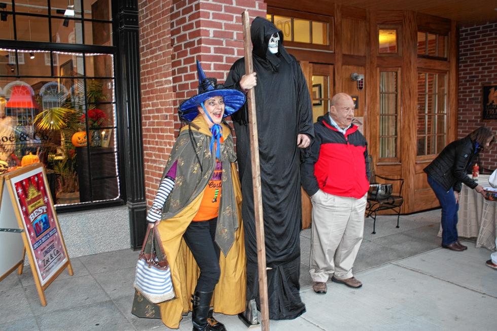 Nina Stevens of Northwood poses for a photo with a really, really tall skeleton guy and a really, really old guy next to Zoe & Co. Professional Bra Fitters. Who says the little ones get to have all the fun? (JON BODELL / Insider staff) - 
