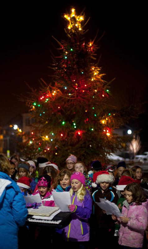 Students from Penacook Elementary School sing Holiday songs at the tree lighting at the Main Square in Penacook Wednesday night. - Concord Monitor
