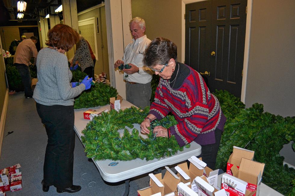 Donna Nordlund strategically places some lights. (TIM GOODWIN / Insider staff) - 
