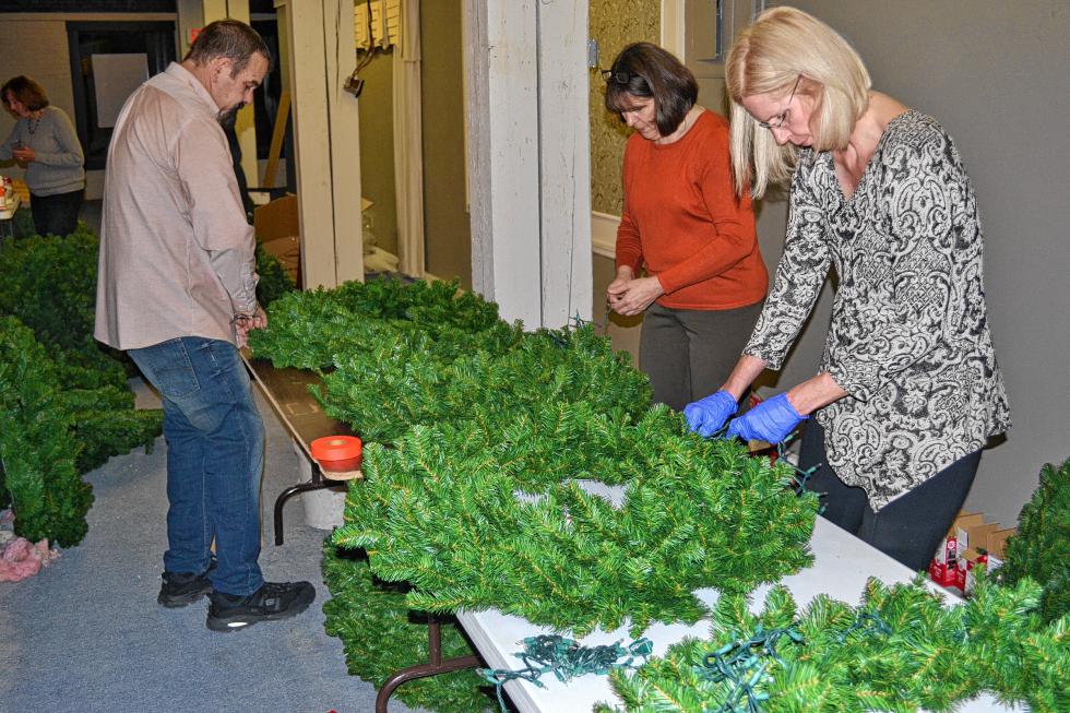 The wreath elves hard at work. (TIM GOODWIN / Insider staff) - 
