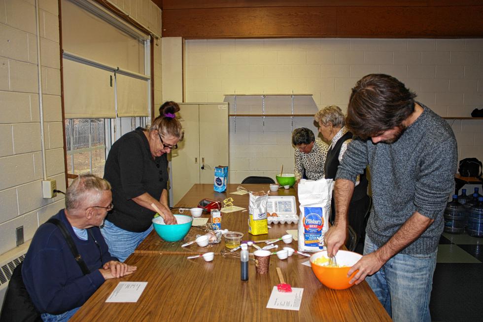 From left: Wesley Shute, Shirley Blad, Sue Edy, Carol Forbush and Jon mix the dough for the cracked sugar cookies. (KARI INGLIS / For the Insider) - 
