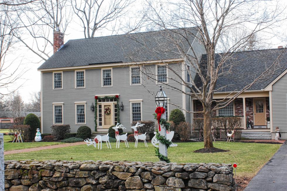 A simple yet pleasant display of white reindeer, wreaths and bows adorns this property on South Curtisville Road. (JON BODELL / Insider staff) - 
