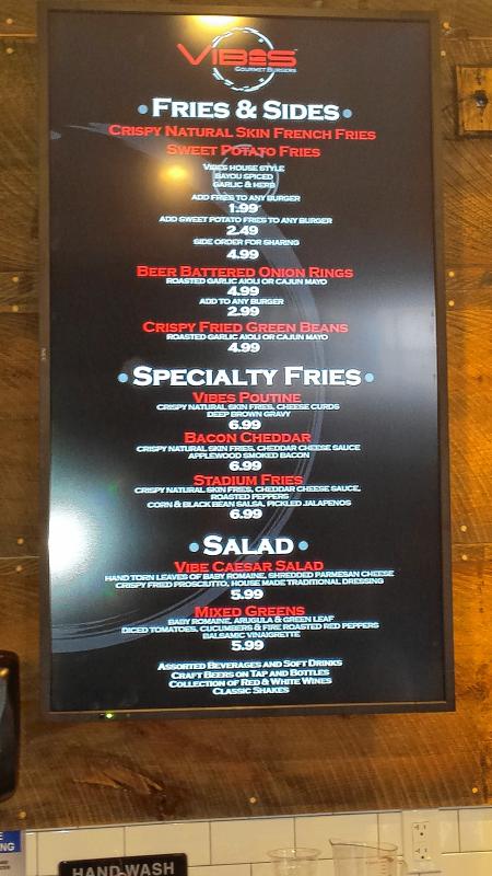 The sides menu at Vibes features poutine, bacon cheddar fries and a couple of salads. (TIM GOODWIN / Insider staff) - 
