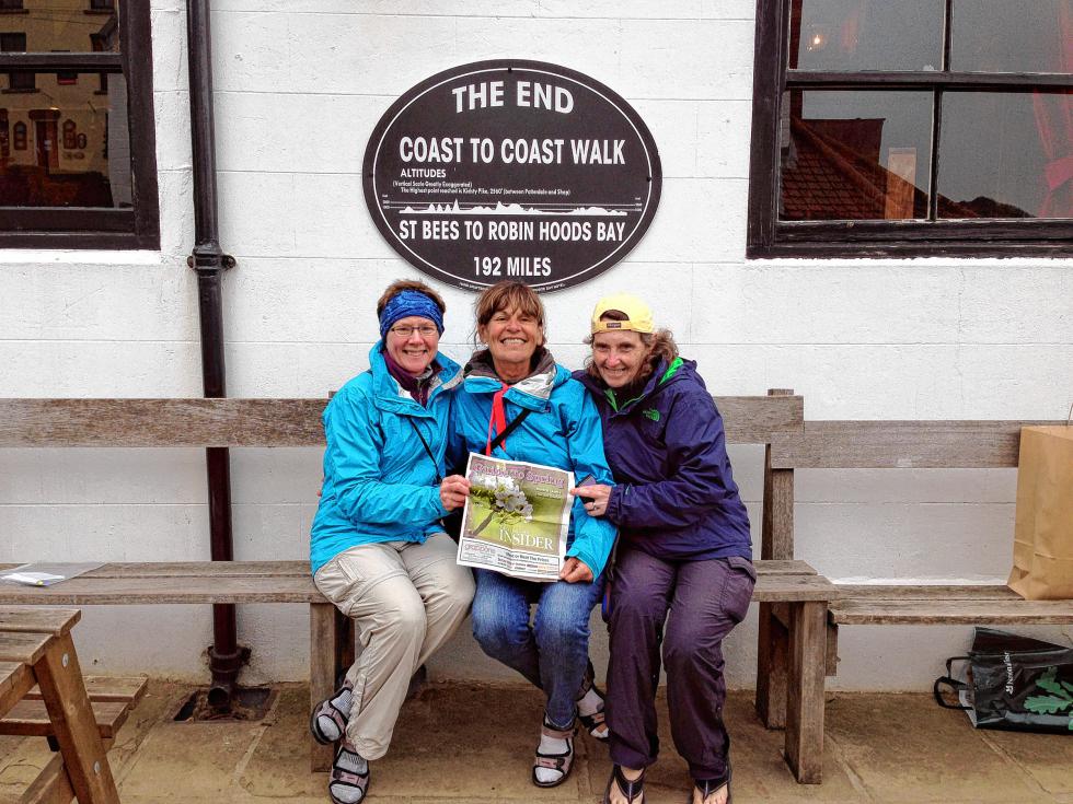 In May, Susan Korjagin of Bow (left) and friends Constance Manchester-Bonenfant and Claire Roberge hiked Wainwright’s Coast to Coast trail – a 192-mile walk across Northern England from the Irish Sea at St. Bees Head to Robin Hood’s Bay and the North Sea. We’d probably never have the energy to walk that much, so we’re glad they just brought a copy of the paper and not us. (Courtesy photo) - 
