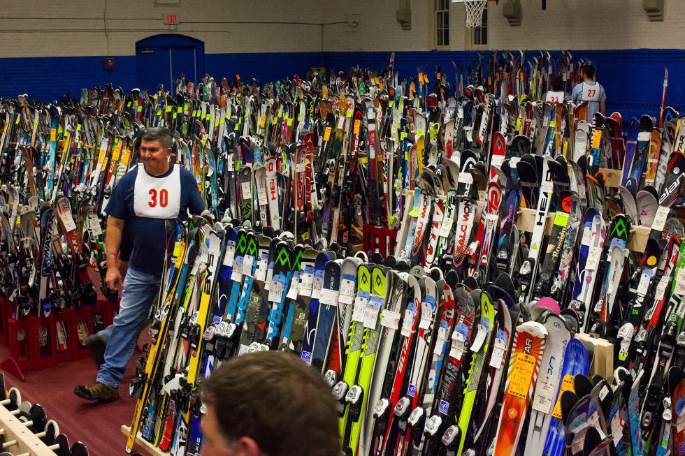 Bill Komisarek of Hopkinton walks through rows of skis during set up for the annual Ski and Skate Sale at the Green Street Community Center in Concord, Thursday, Dec. 4, 2014.  (ELIZABETH FRANTZ / Monitor staff) - ELIZABETH FRANTZ | Concord Monitor
