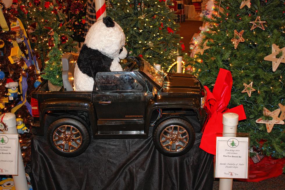 The Banks Family of Auto Dealerships donated this cool Trucking into Christmas tree. It's not so much a tree as it is a one-seat convertible pickup truck being driven by a panda. Oh yeah, and there's a little Christmas tree in the back. (JON BODELL / Insider staff) - 

