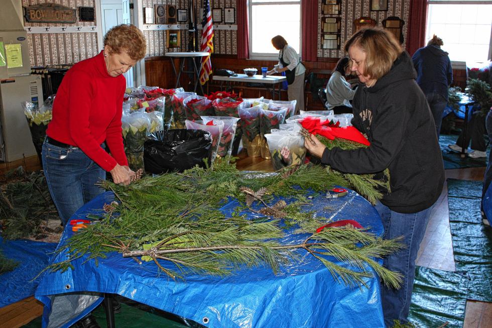 Susan Smith (left) and Sharon Pearce of the Bow Garden Club put some swags together at Bow's Old Town Hall last week. (JON BODELL / Insider staff) - 
