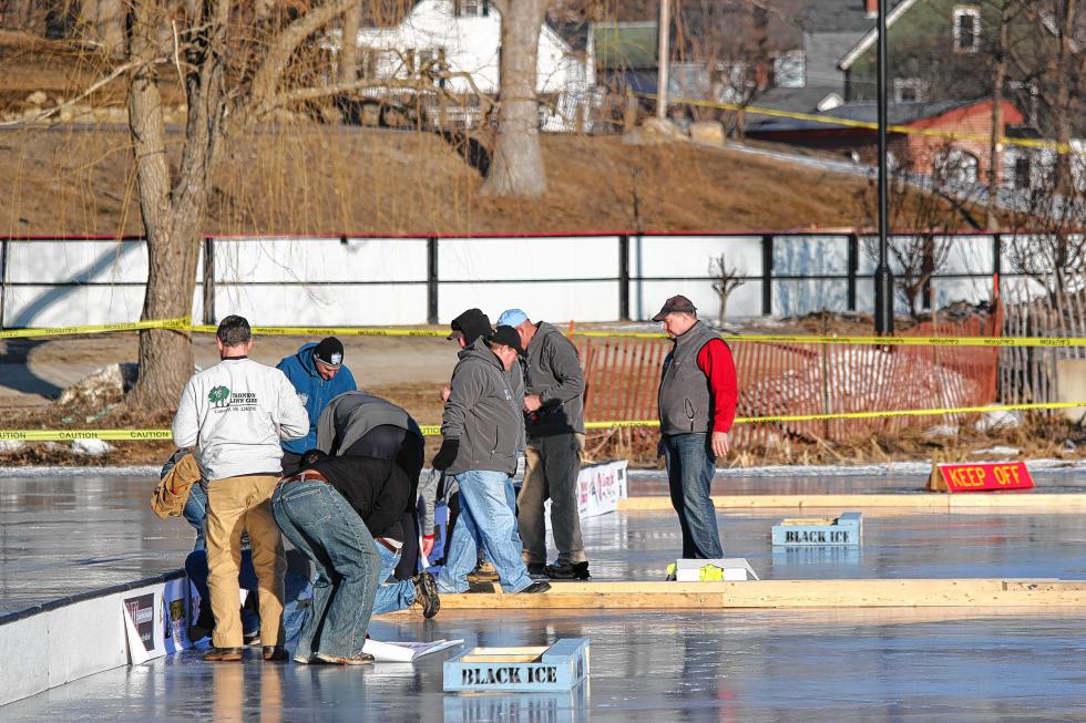 Volunteers help set up for the 1883 Black Ice Pond Hockey Championship at White Park in Concord. These guys work efficiently – the whole thing comes together in a single day. (Courtesy) -