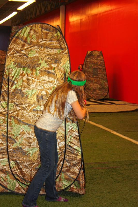 Edna Frost, 11, takes cover behind a tent during a laser tag match. (JON BODELL / Insider staff) - 
