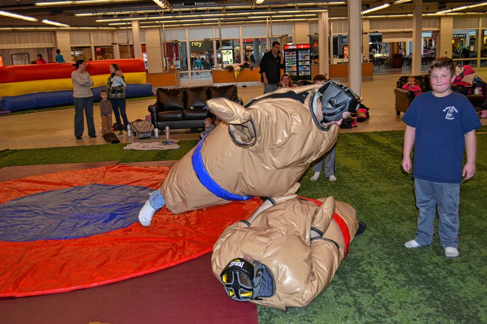 Chris Smykil belly-flops onto Jon White in the Sumo wrestling ring inside Bounce House Entertainment Center. Good thing they were wearing those suits! (TIM GOODWIN / Insider staff) - 

