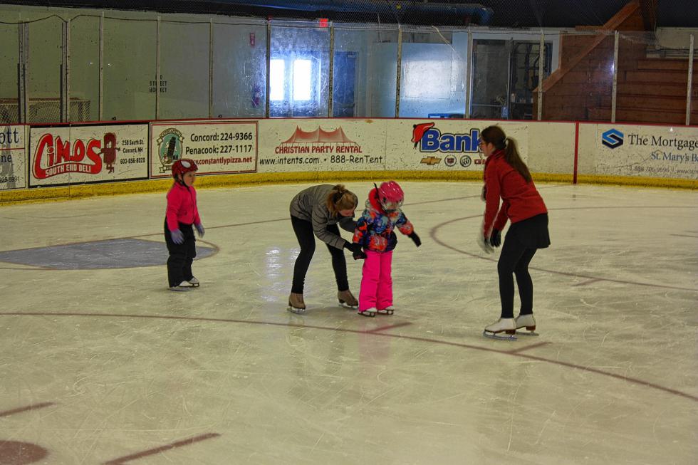 Skating instructors Kari Inglis (right) and Cathi McDonnell with Concord Parks and Recreation help Kayda, 4, keep her balance while Alaina goes nice and slow behind them. There were a few falls during the lesson, but the girls were eager to get right back up and keep trying. (JON BODELL / Insider staff) -