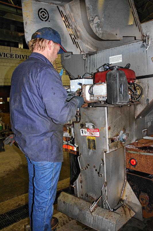 Don Weaver makes some repairs to a starter solonoid of a sander in the garage at the General Services Department headquarters on North State Street. There's always a need for a good mechanic during a snowstorm. (JON BODELL / Insider staff) - 
