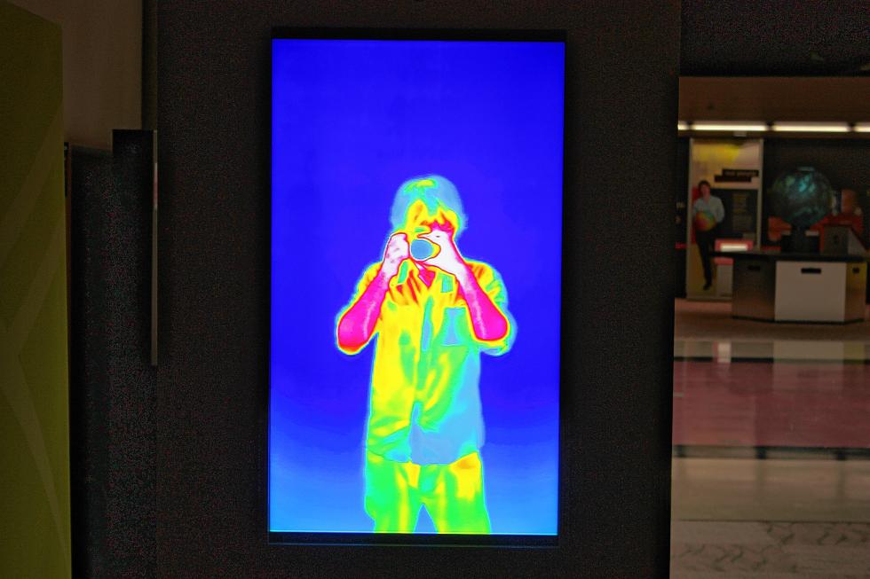The Discovery Center has an exhibit all about the light spectrum. Here I am – in infrared form – taking a picture of myself. Looks like my forearms were pretty hot at the time of this photo. (JON BODELL / Insider staff) -