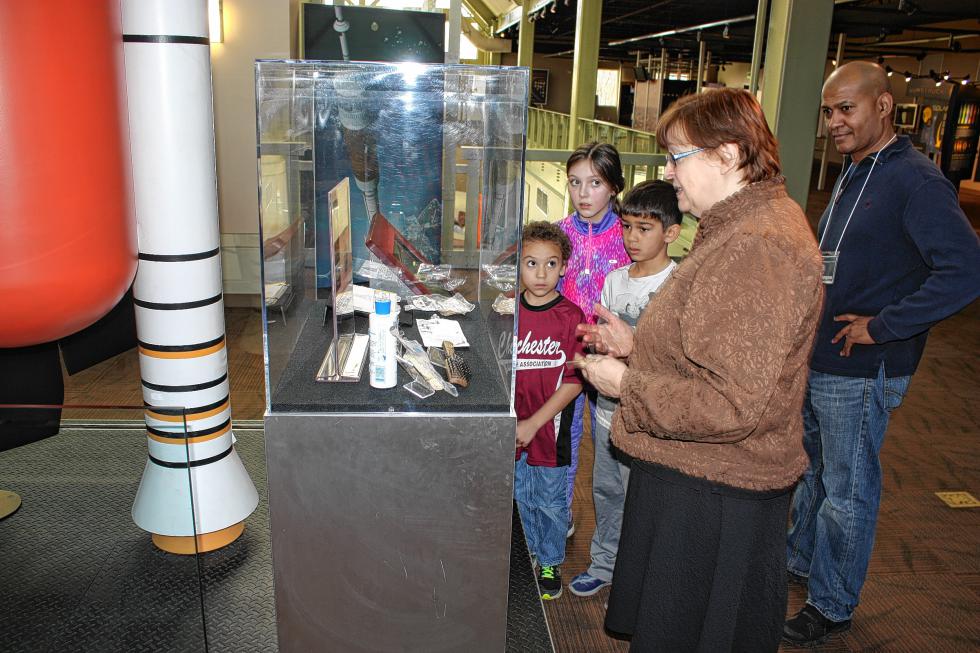 From left: Trevor Monterio, Ellie Smith and Evan Berkeley – all Chichester Central School students – listen to Jeanne Gerulskis, the Discovery Center's director, talk about some space items. Evan's dad, Ian, was also pretty fascinated. (JON BODELL / Insider staff) -