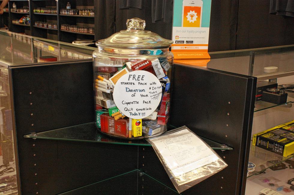 A jar full of cigarette packs sits on a counter at SubStyle Vapors. (JON BODELL / Insider staff) -