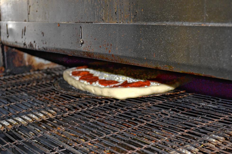 Into the oven it goes. It will stay in for about eight minutes at about 450 degrees. (TIM GOODWIN / Insider staff) -