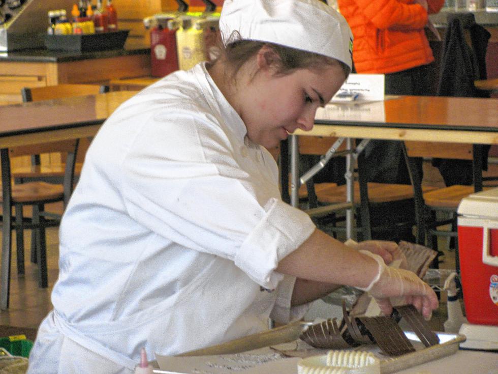 Katherine Killam works on the chocolate curls for the team’s dessert. (Courtesy photo) -