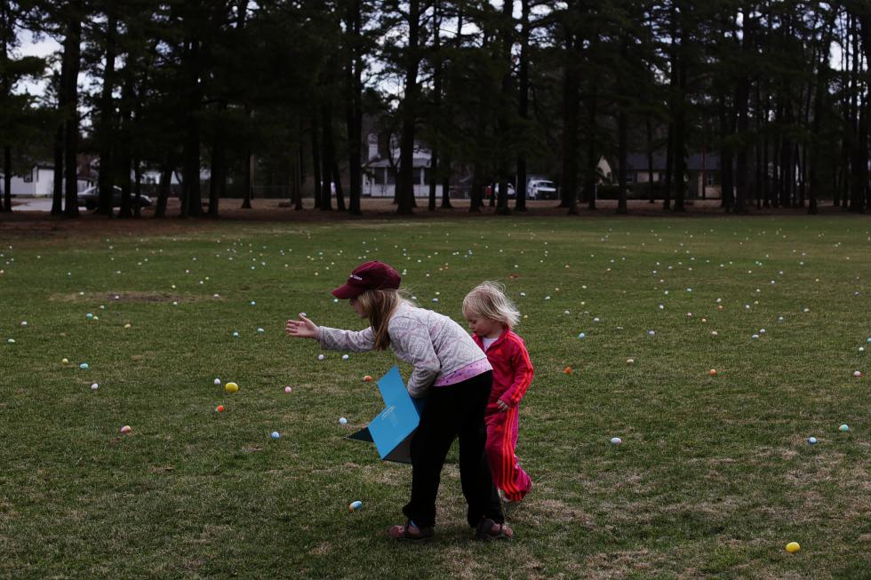 Ellie Clarner, 9, tosses an egg out in the field at Keach Park while getting ready for the Easter egg hunt on Saturday morning, April 19, 2014.   (ANDREA MORALES / Monitor staff) - Andrea Morales | Concord Monitor