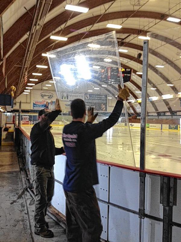 Workers with Concord General Services take down one of the glass boards at Everett Arena last week. (Courtesy of Concord General Services) -