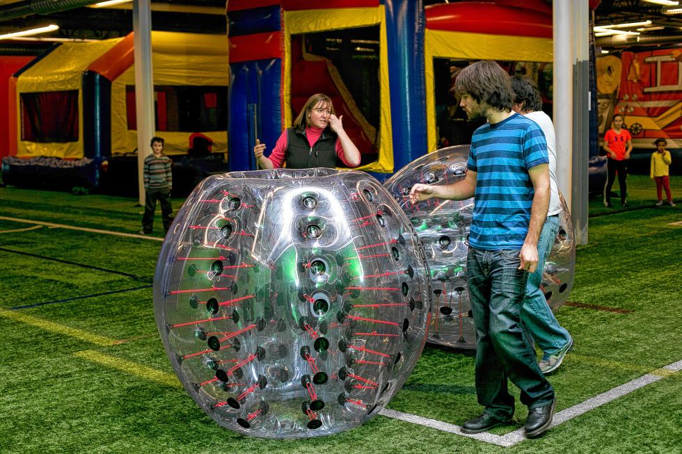 Tim and Jon get a littlle tutorial before climbing into the big inflatable balls. (GEOFF FORESTER / Monitor staff) -