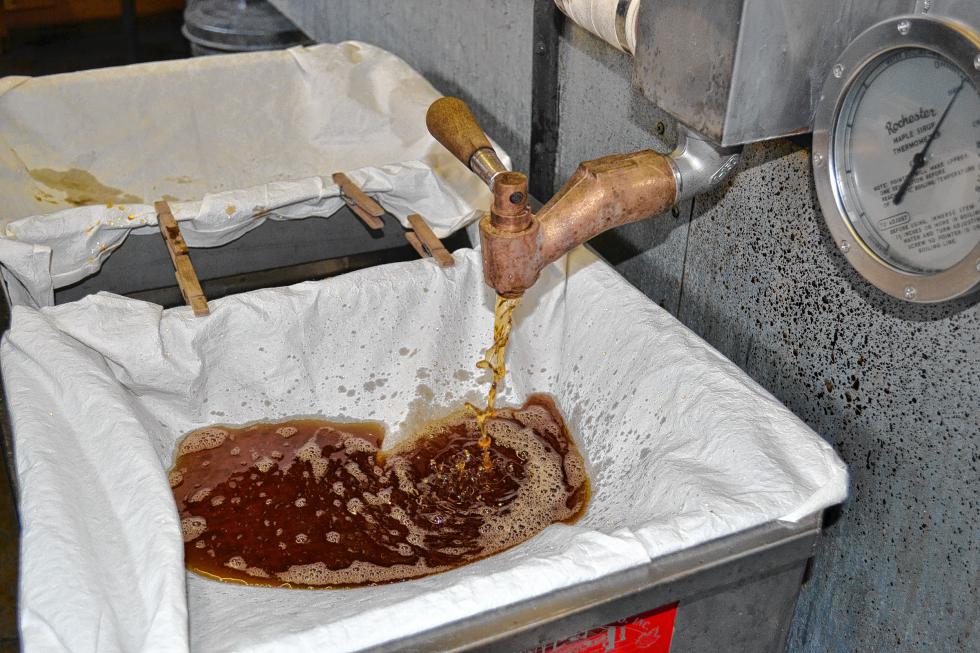 Syrup, at 219 degrees, is poured through a filter at Mapletree Farm. (TIM GOODWIN / Insider staff) -