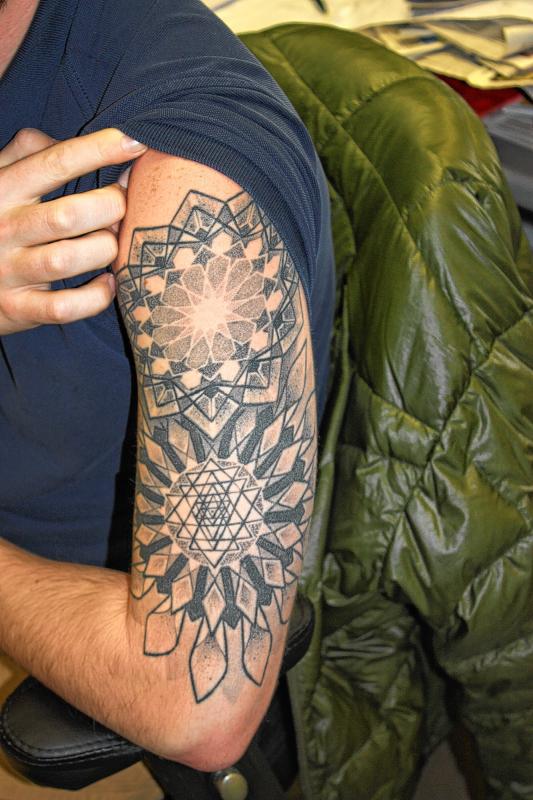 Nick Reid, news reporter: My tattoo is of two geometric-themed mandalas on my upper left arm. It was custom-drawn by Abby Williams, an artist who previously worked out of Brilliance Tattoo in Boston. We talked together about patterns and shapes, and she turned our conversations into a piece of art. (JON BODELL / Insider staff) -