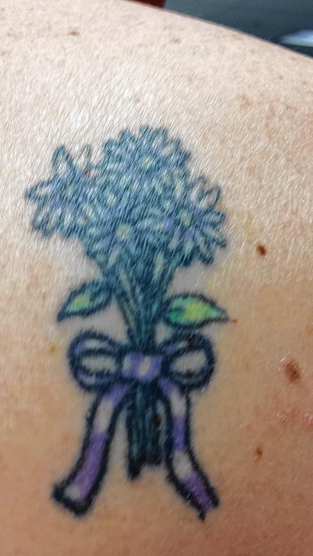 Leean Hewitt, single-copy manager: I received this tattoo for my 46th birthday in memory of my mother. The tattoo was a gift from my daughter. There are four daisies – one for each of my daughters, one for me and one for my mother.  (Courtesy) -