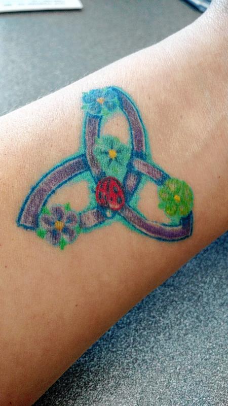 Cathy Valley, advertising assistant: I have one on my left inside forearm. It's a celtic triquetra. The flowers are the birthstone colors for my 2 kids, my husband and me and the ladybug in the middle is for luck. It was a birthday present from my best friend last April. I got it done in Newport at Rick's Tattoo. Really nice guy. (Courtesy) -