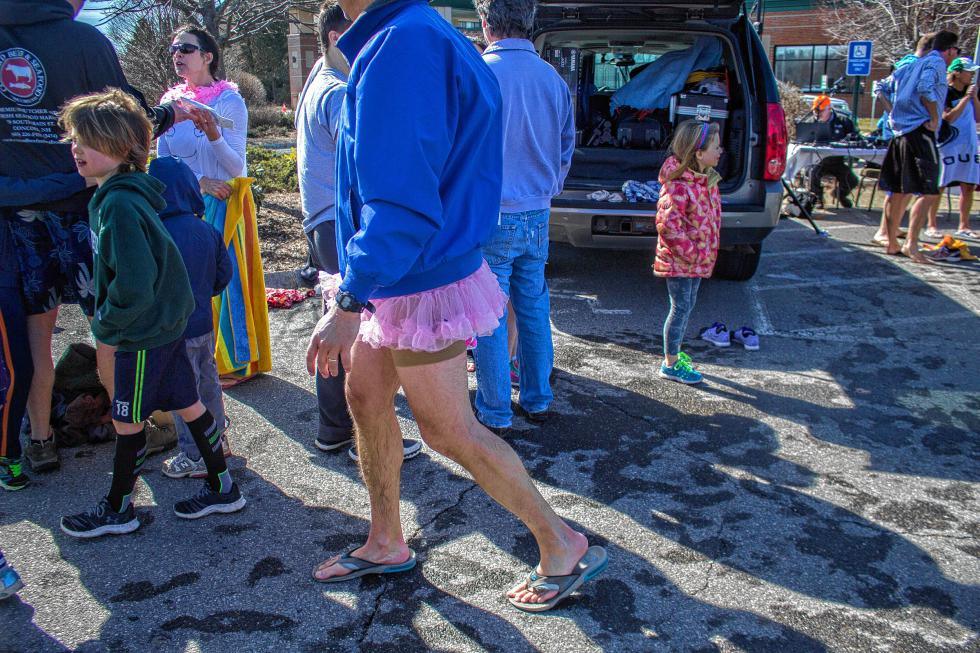 Concord resident Ray Orzechowski, in the tutu, walks away from the Womenade Polar Plunge event in Concord Sunday.   (ELODIE REED/ Monitor staff) - ELODIE REED | Concord Monitor