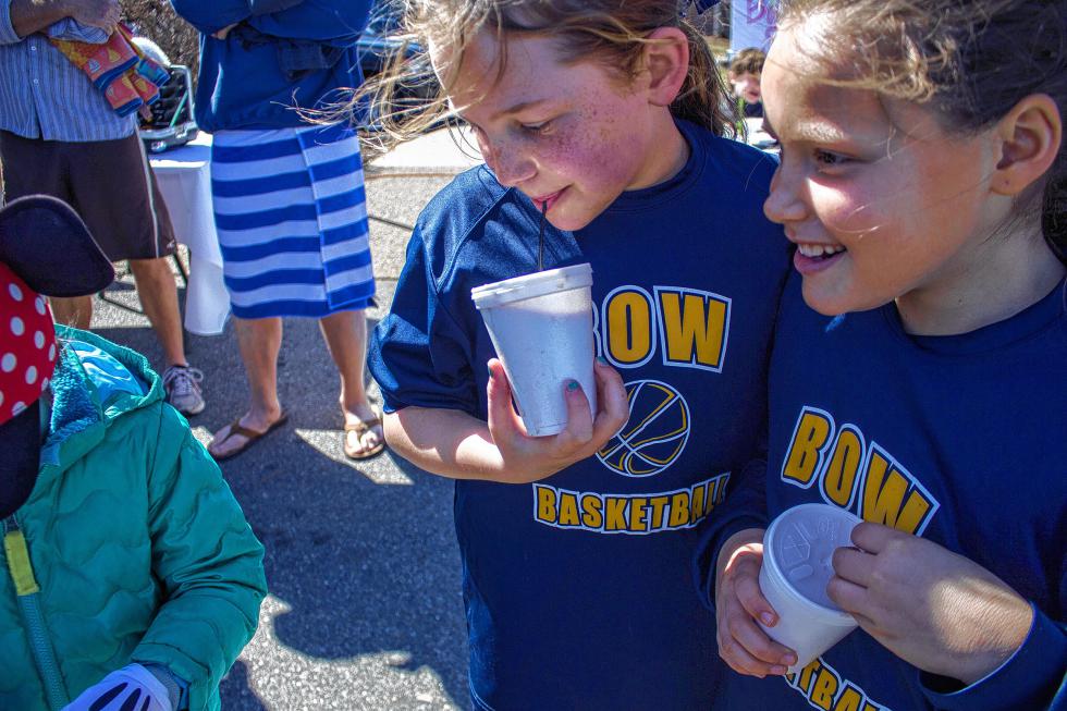 Emma Kelley, left, and Cindy Roberge, right, both 10 and from Bow, drink hot chocolate at the Womenade Polar Plunge event in Concord Sunday.   (ELODIE REED/ Monitor staff) - ELODIE REED | Concord Monitor