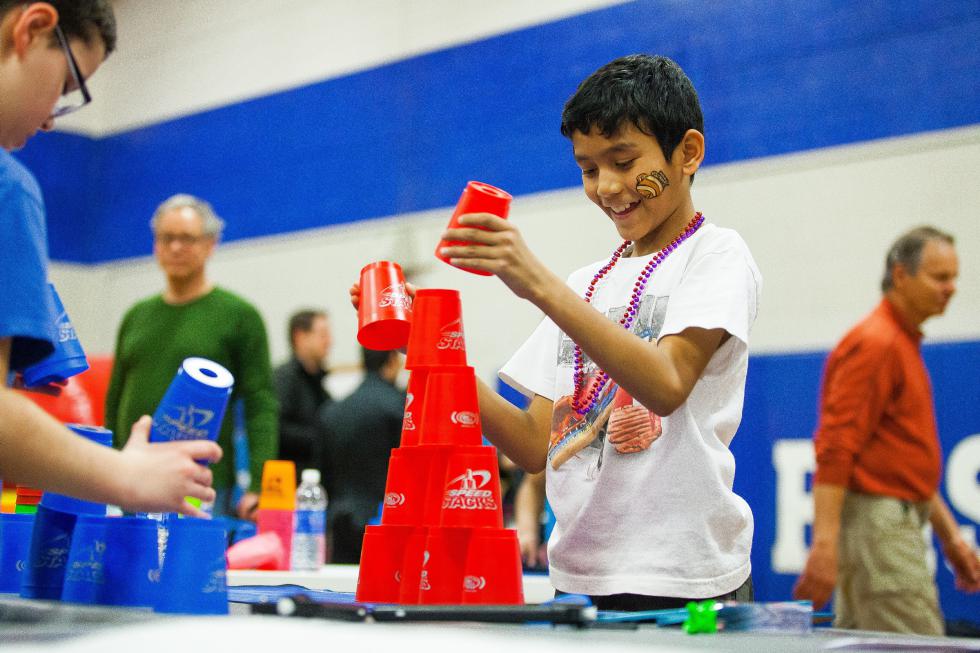 Ajay Darjee (right), 11, and Tyler Carrier, 9, show off their cup stacking skills during SouperFest, a community event held at Rundlett Middle School in Concord to benefit the Concord Coalition to End Homelessness, on Saturday, March 28, 2015.  (ELIZABETH FRANTZ / Monitor staff) - ELIZABETH FRANTZ | Concord Monitor