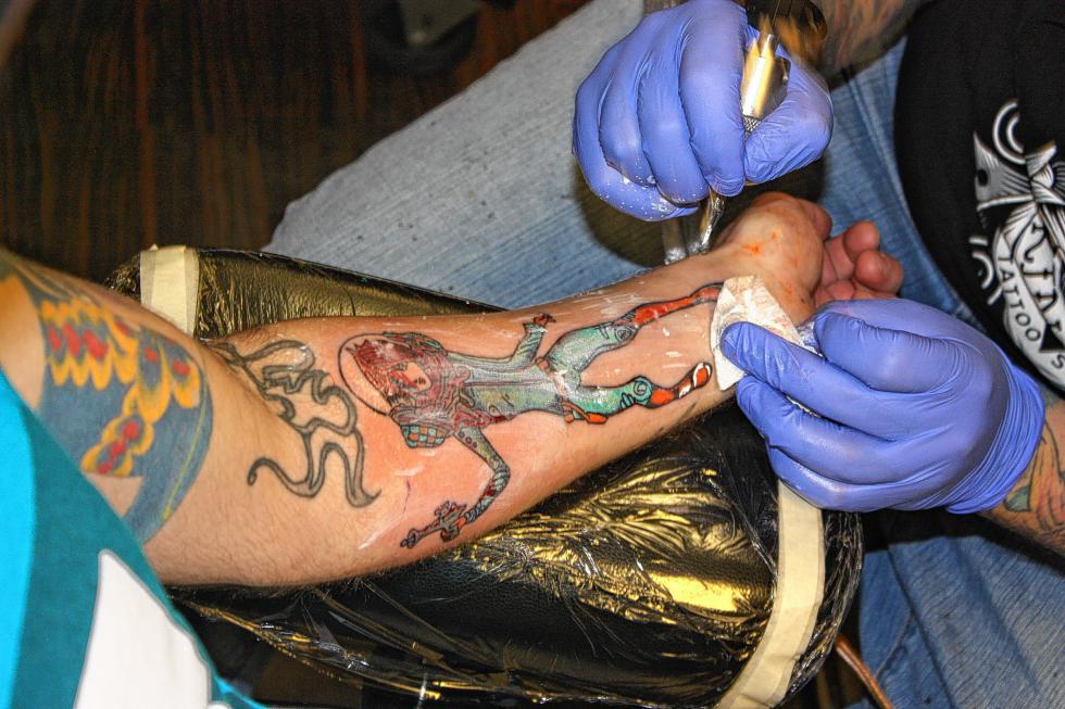 Almost done! Collins adds some white touches just to make the tat pop a little more. (JON BODELL / Insider staff) -