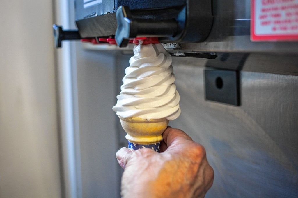 Elizabeth Frantz—Concord MonitorOwner Norm Ballard demonstrates use of the soft serve machine at Ballard's Ice Cream in Concord on Wednesday