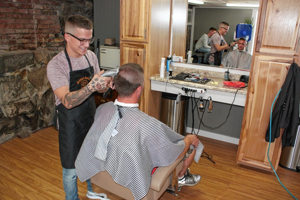 JON BODELL / Insider staffDylan Adams, one of the owners of Brothers Barber Company, cuts the hair of Casey Crumb at Brothers last week. This was Crumb’s first trip to the new barber shop, but he’s had his hair cut by Adams for years.