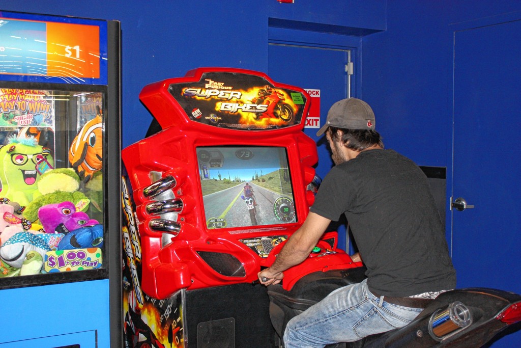 JULIA MAKRIS / For the InsiderJon gives it a go on “The Fast and the Furious Super Bikes” game at the Wal-Mart arcade.