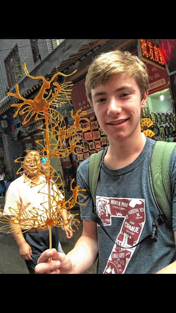 Courtesy of Andrew LeonardConcord High sophomore Andrew Leonard shows off his honey dragon he got from a street vendor in the Muslim Quarter of Xi’an, China, where he stayed for seven weeks. The vendor makes the design out of honey on a hot surface right in front of you. Once it hardens you have a sweet, edible dragon on a stick.