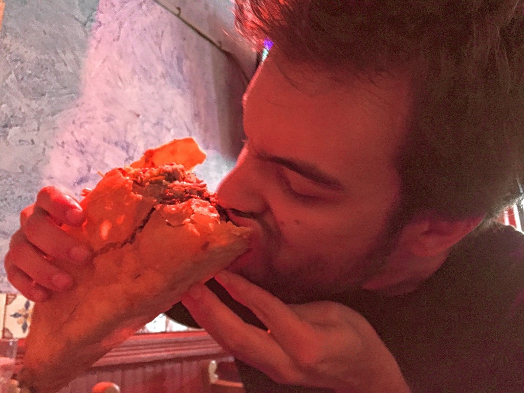 Jon takes a big bite of his big taco. It looked so promising early on! If only he prepared the way Tim did – by eating pizza at 10:30 a.m. to stretch the stomach.
