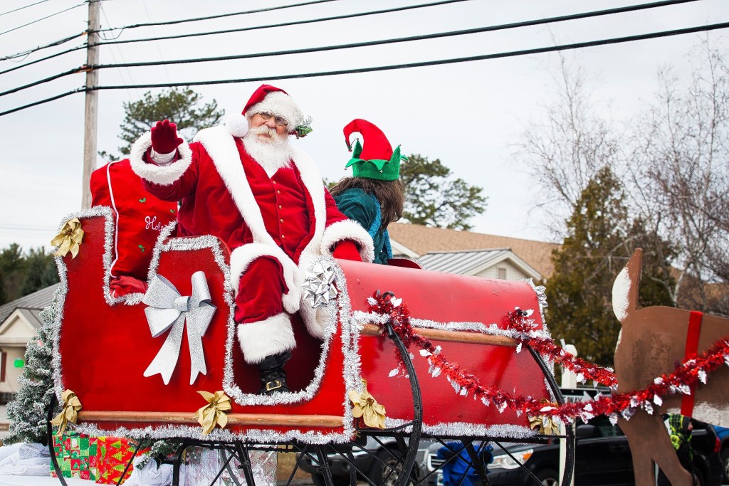 Santa Claus waves to the crowd during the annual Christmas parade on the Heights on Saturday, Nov. 22, 2014.