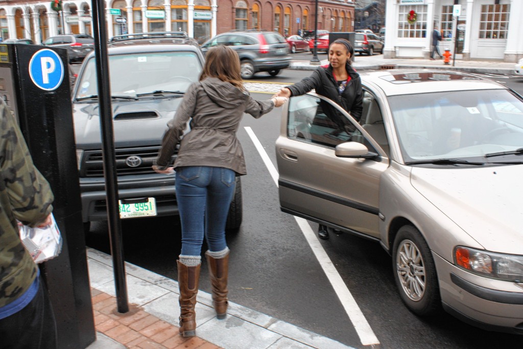 Grace Milliken hands a stranger a little goodie bag on Main Street in December 2015.