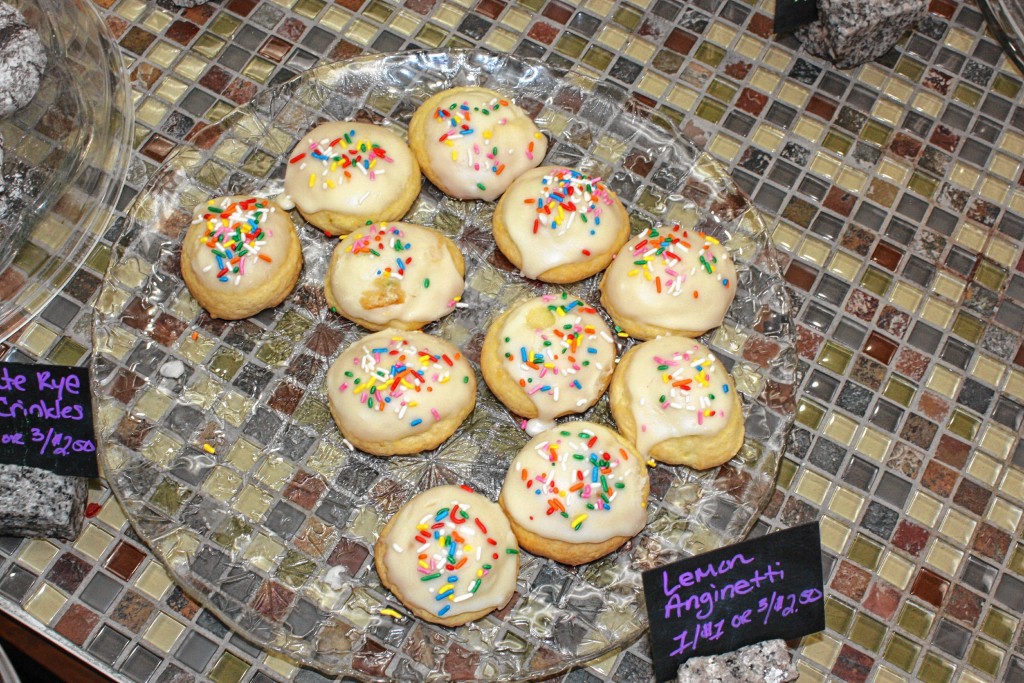 Top right: At New England Cupcakery, there are some gingerbread cupcakes to hold you over until the week of Dec. 20, when virtually all of the cupcakes will be red, green and generally Christmasy. Top left: Gingerbread people are a staple at Crust and Crumb, as are mitten cookies (middle) and lemon anginettis (above). We’ll take a dozen of everything, please!