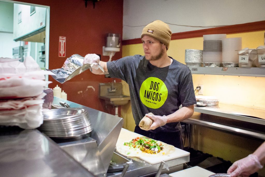 Dos Amigos Burritos employee Tyler Castrogiovanni makes burritos at the downtown Concord restaurant on Thursday, Jan. 19, 2017. Dos Amigos will be closed from February 1-22 during an expansion and renovation project.(ELIZABETH FRANTZ / Monitor staff)