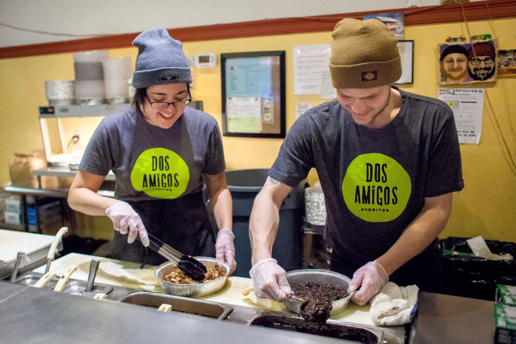 Dos Amigos Burritos manager Kina Gilson (left) and employee Tyler Castrogiovanni fill a catering order at the Concord restaurant last week. Dos Amigos will be closed from Feb. 1-22 during an expansion and renovation project.