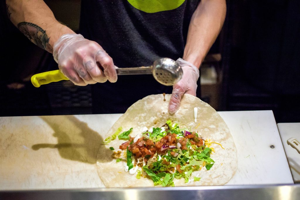 Dos Amigos Burritos employee Tyler Castrogiovanni works on a customer order at the downtown Concord restaurant on Thursday, Jan. 19, 2017. Dos Amigos will be closed from February 1-22 during an expansion and renovation project.(ELIZABETH FRANTZ / Monitor staff)