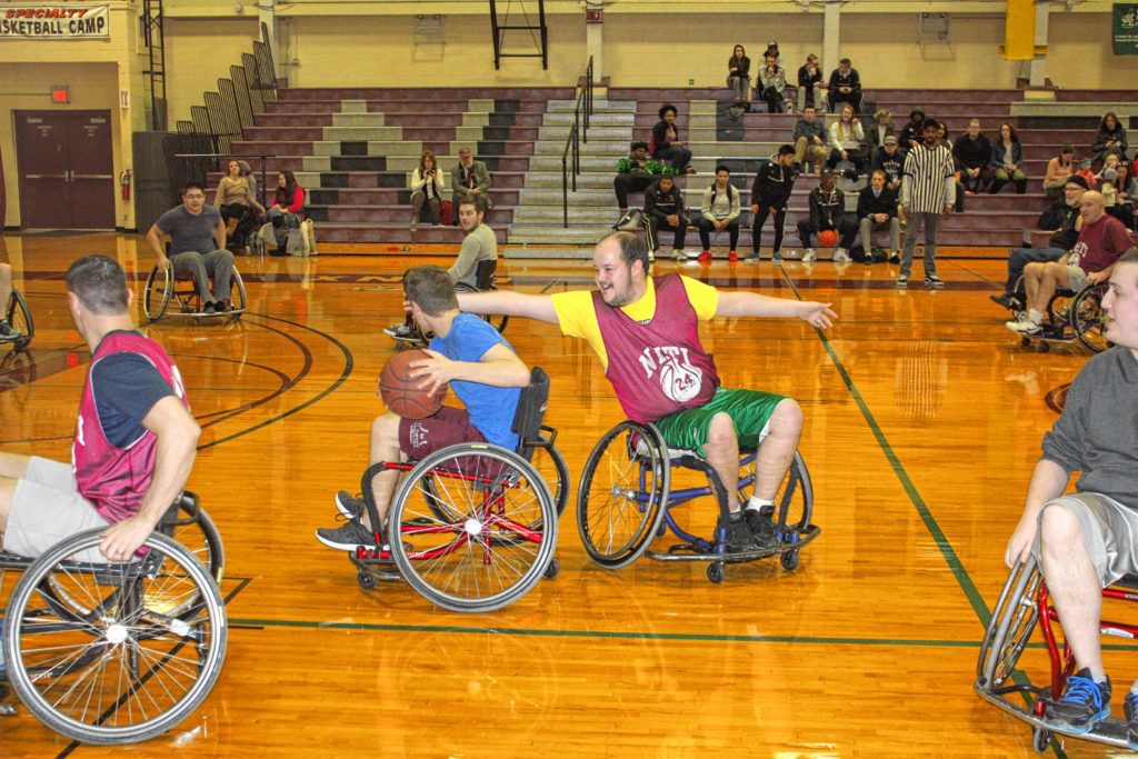 Mike Martineau plays some seriously in-your-face defense during the Wheelchair Basketball Benefit at NHTI last week. (JON BODELL / Insider staff)